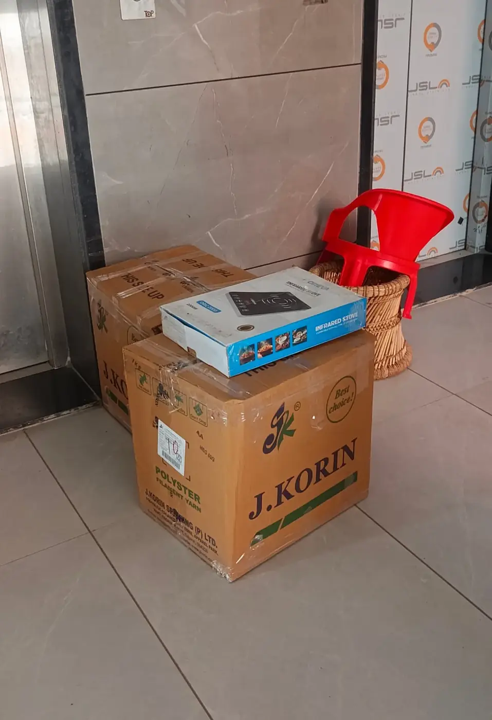 Packed cartons and appliances staged for a home relocation in Surat