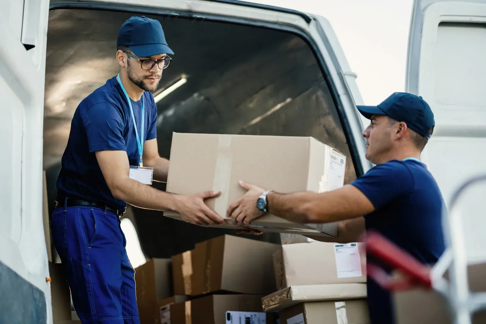 Movers and packers Surat crew unloading labelled cartons at a customer's new home